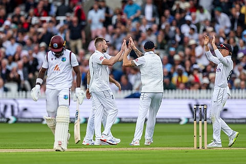 Gus Atkinson and Zak Crawley celebrate wicket of  Kirk Mckenzie